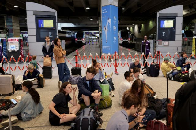 Passengers sitting on the floor at the Gare Montparnasse