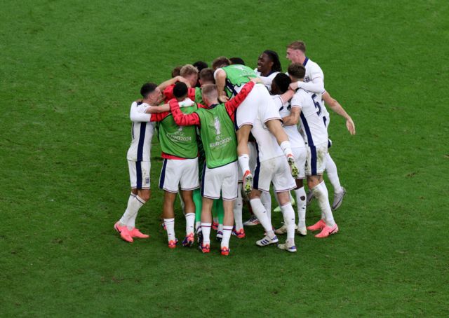 England team celebrate round of sixteen win together in huddle