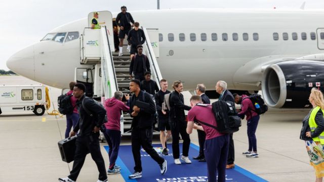 England players disembark an airplane at the airport Erfurt-Weimar ahead of the Euro 2024 on 10 June