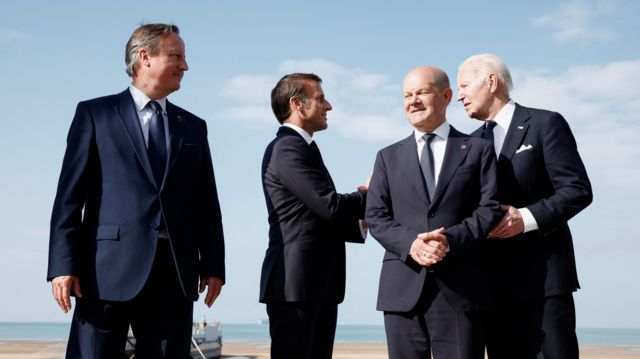 David Cameron stands with world leaders in Normandy