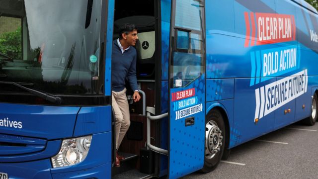 Rishi Sunak exits his campaign bus in Carterton