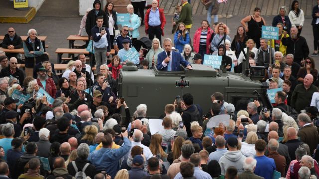 Reform UK leader Nigel Farage addresses voters in Clacton from an army vehicle