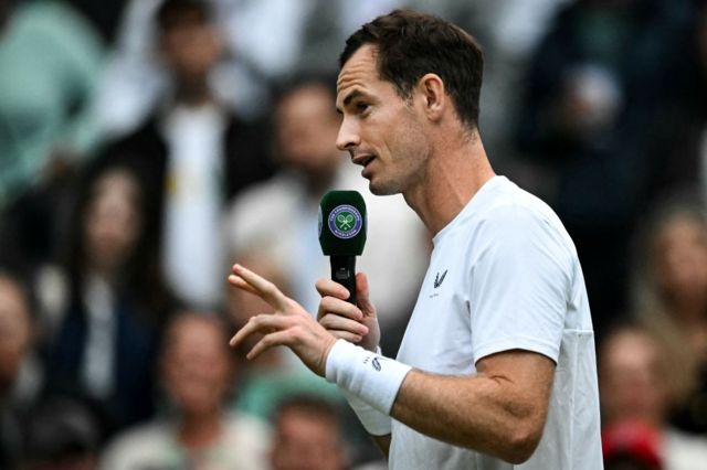 Andy Murray speaks with a microphone on Centre Court