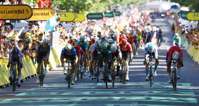 Dylan Groenewegen lunges for the line to win stage six of the 2024 Tour de France
