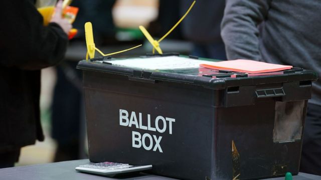 A black ballot box on a table