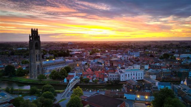 Sunrise over Boston taken by a drone, showing St Botolph's church and the River Witham