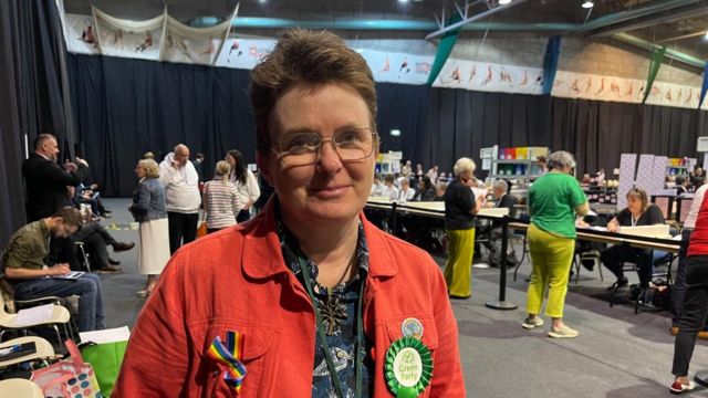 Marion Turner-Hawes wearing a red jacket and Green rosette at a count