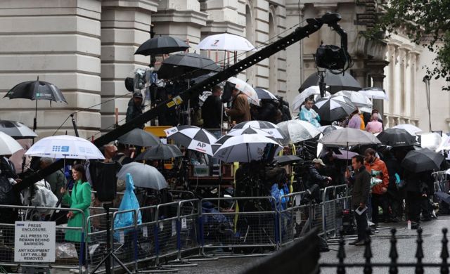 Press in rain outside Downing Street