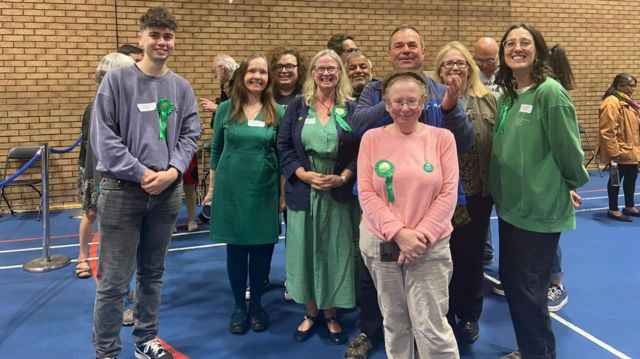 Green party candidate Rachel Cabral, middle, surrounded by rosette-wearing Green Party supporters