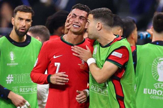 Cristiano Ronaldo consoled by Diogo Dalot