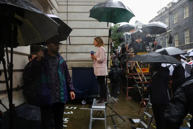 Members of press in the rain outside Downing Street