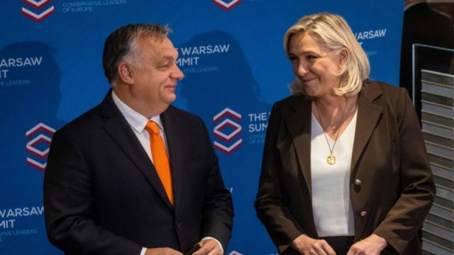 Orban and Le Pen smile at each other