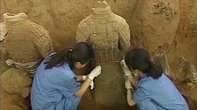 Archaeologists excavating a terracotta warrior