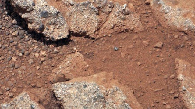 Image provided by NASA shows a Martian rock outcrop near the landing site of the rover Curiosity, thought to be the site of an ancient streambed.