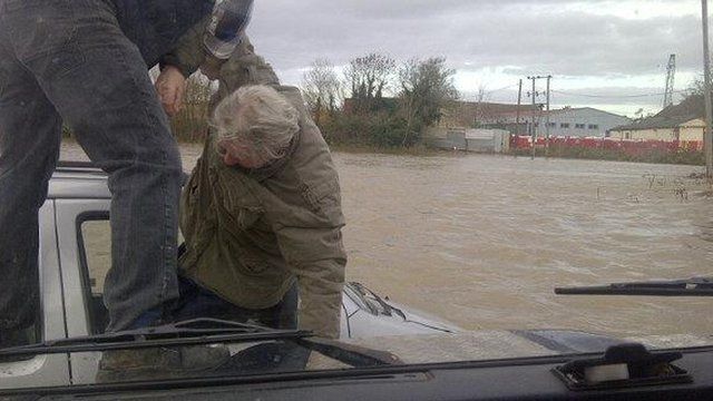 David Dunn pulls an elderly man from his car as it sinks in flood water at Keynsham