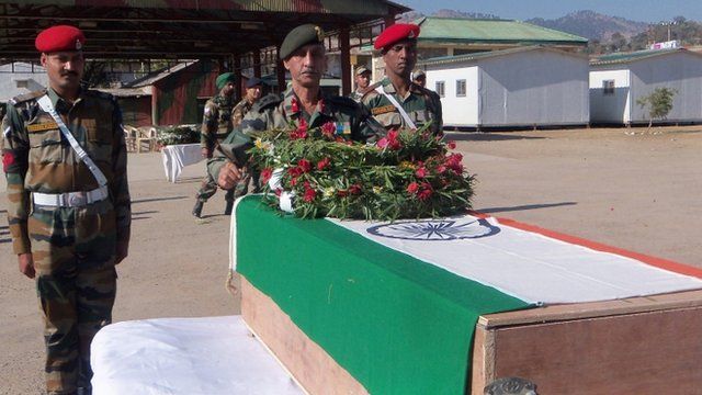 Indian Army officers laying a wreath on a coffin