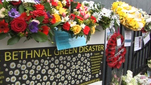 Floral tributes are laid on railings outside Bethnal Green tube station