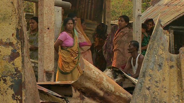 Bangladesh villagers stand in damaged buildings after attack
