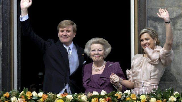 Princess Beatrix of Netherlands, her son, Dutch King Willem-Alexander and his wife Queen Maxima waving to crowds from a balcony