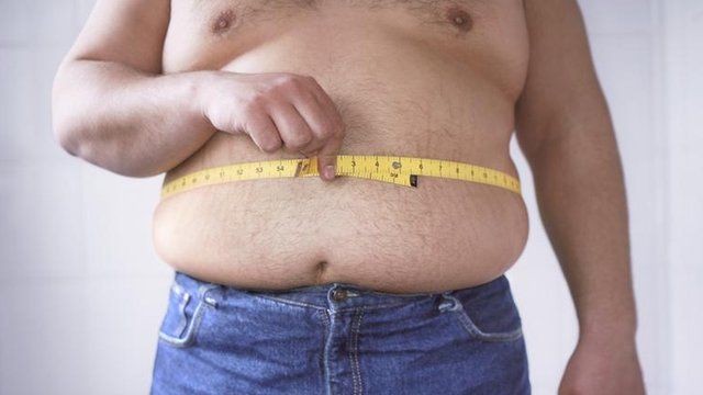 A man measuring his waist
