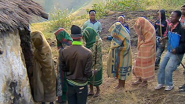 Young men getting into a hut