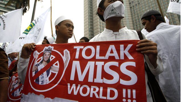 Protesters display a banner during a protest calling for the cancellation of the Miss World pageant in Jakarta