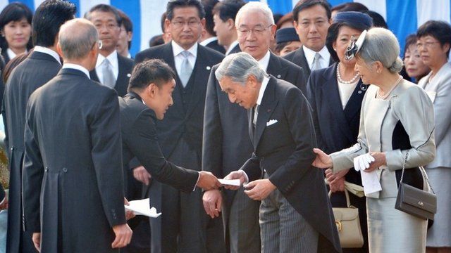 Japanese actor and politician Taro Yamamoto (3rd L) hands a letter to Emperor Akihito (front C) during the annual autumn garden party at the Akasaka Palace imperial garden in Tokyo on October 31, 2013.