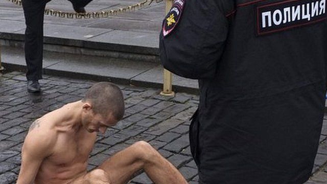 Performance artist Pyotr Pavlensky sits nailed to Red Square, 10 November