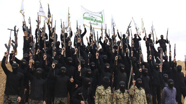 Islamist fighters dressed in black with rifles