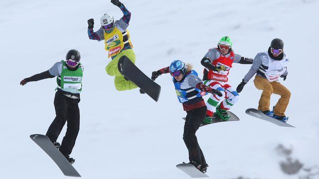 Athletes compete in the snowboard cross