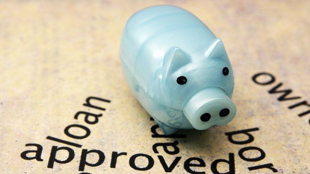 Traditional savings piggy bank on cluster of financial buzzwords