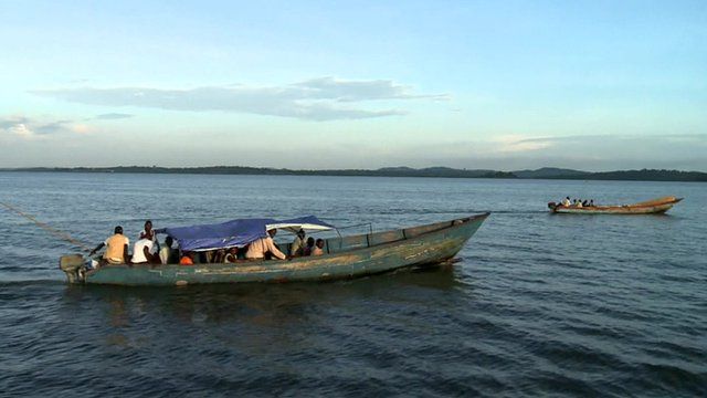 Two boats carrying people across a lake