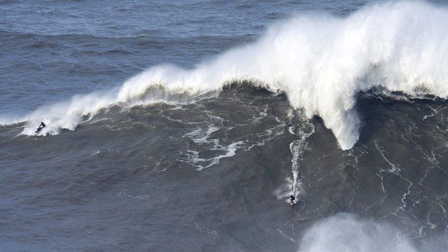 Andrew Cotton riding an enormous wave