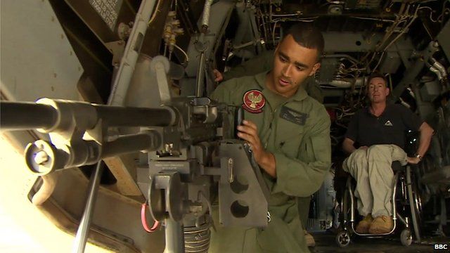 US Marine gunner, Hernandez, demonstrates weaponry on board MV-22 Osprey aircraft