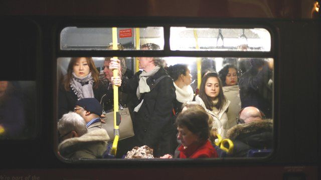 Commuters on a busy bus