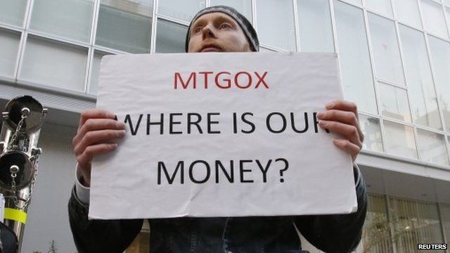 Kolin Burges holds a placard to protest against MtGox