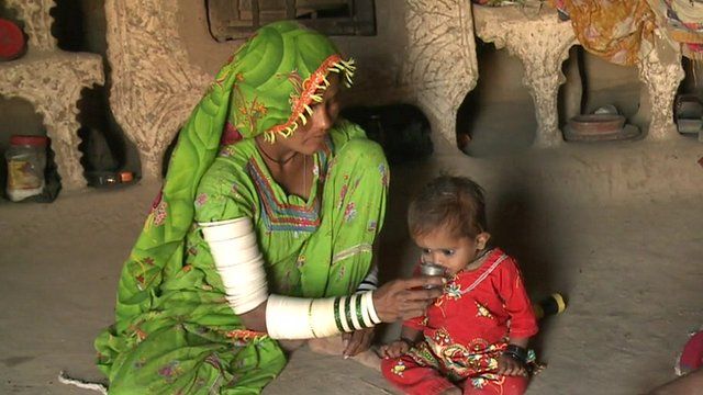 A mother feeding her child in the Thar desert region of Pakistan