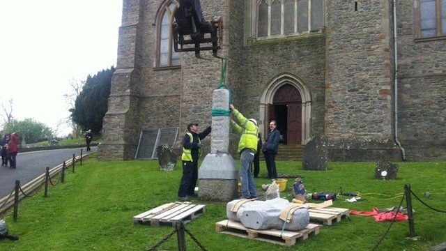 The replica stone is eased into position at Down Cathedral