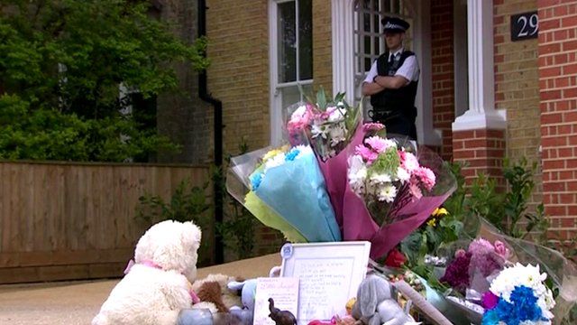 Tributes at house, under police guard