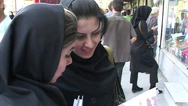 Two Iranian women wearing headscarves, but showing their hair in the street