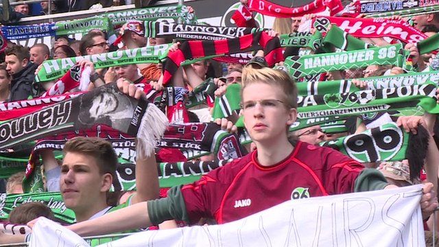 Football fans holding banners in Hanover, Germany