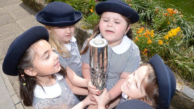 School children from Market Square Preparatory School Reception year hold The Commonwealth Baton as it makes its way around the Isle of Man