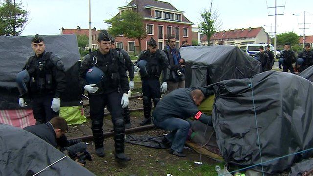 Police search tents at the camp in Calais