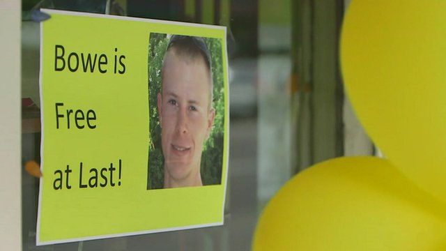 Yellow balloons and poster reading 'Bowe is free at last'