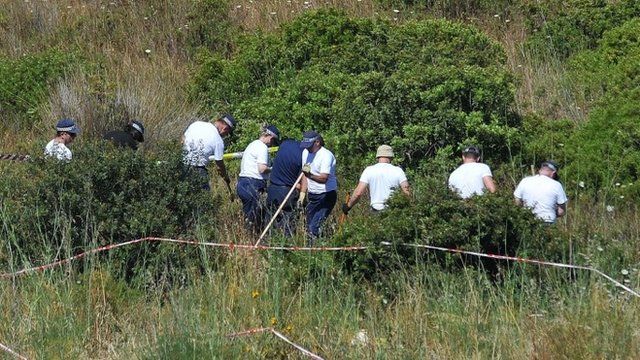 Police searching scrubland