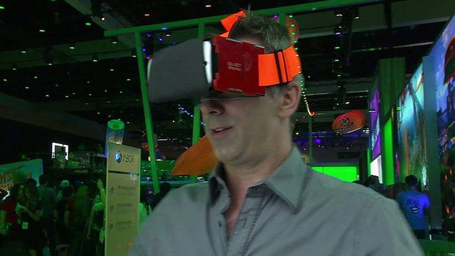 Spencer Kelly wears a virtual reality headset which uses a smartphone as the screen