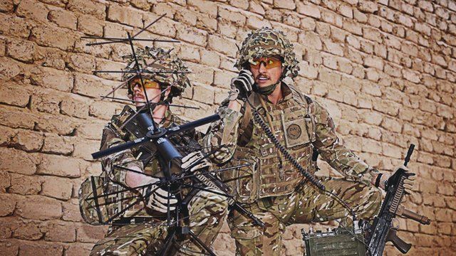 Royal Marines testing communications equipment before going out on patrol in Afghanistan