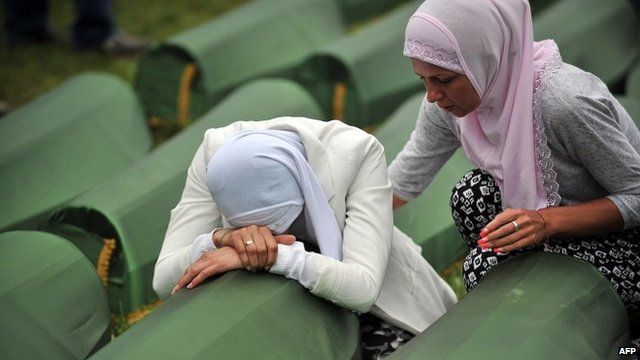 Bosnian Muslim woman cries by the coffin of a relative