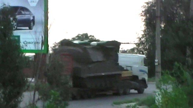 Truck apparently carrying an SA-11 missile launcher heading back to Russia