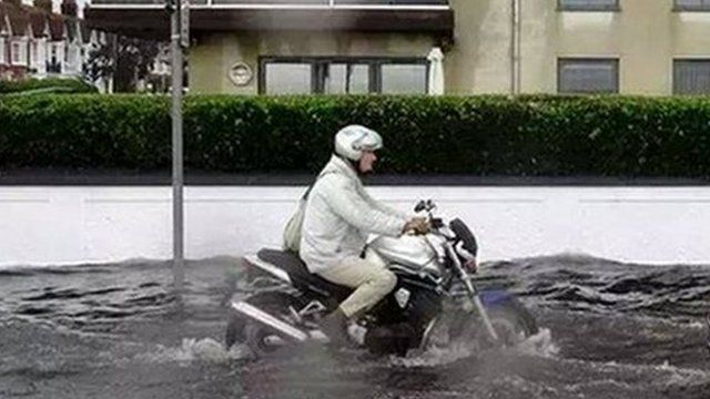 Man on motorcycle in Worthing flash flooding